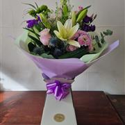 Florist choice hand tie in clear acrylic vase